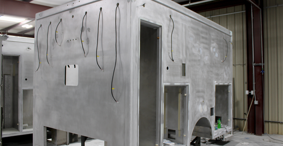 Front driver side view of Type I ambulance for Colquitt #2687 in paint and body prep.