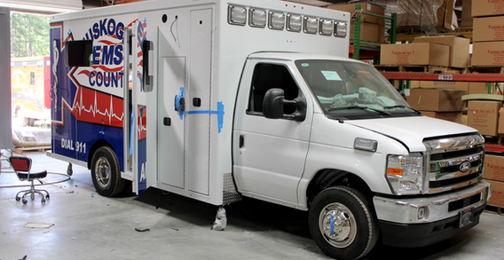 Front curbside corner view of Type III ambulance for Muskogee #2653 getting graphics.