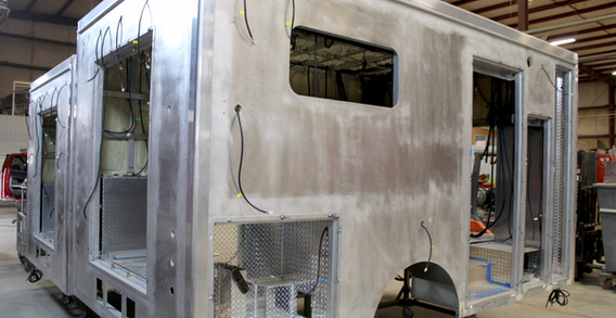 Rear curbside corner view of CNC cut rear entrance, side window, and compartments for Muskogee #2655 Type III ambulance from Custom Truck and Body Works, Inc.
