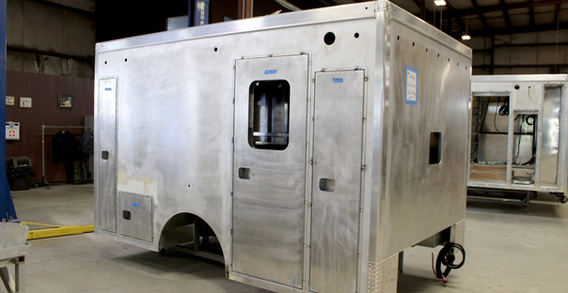 Front curbside corner view of Calhoun #2662 Type I ambulance in welding and fabrication.