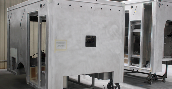 Front curbside corner view of Type I ambulance for Calhoun #2662 in paint and body prep.