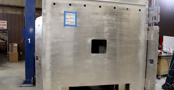 Front wall view of Type I ambulance for NEFEA #2663 on welding and fabrication lift.