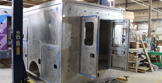 Rear driver side corner view of Cushing #2585 on welding and fabricaiton lift.