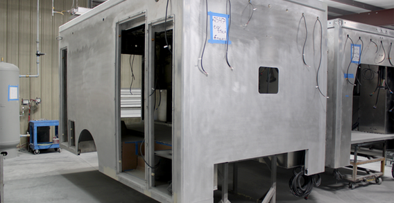 Front curbside corner view of EVO Stock #2547 in paint and body prep.