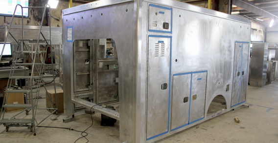 Front driver side corner view of metal Type III ambulance in beginning welding and fabrication.