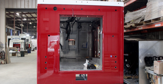 Rear view of Red and White painted Type I ambulance with some interior and electrical showing.