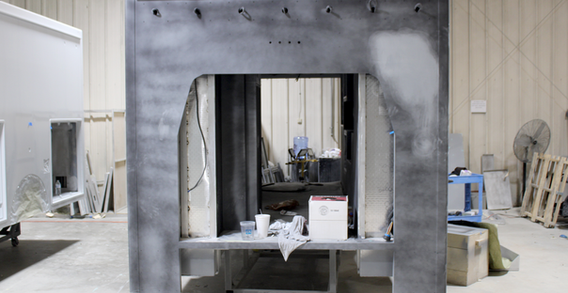 Front wall view of Muskogee #2653 in paint and body prep. Type III ambulance getting sanded and smoothed after primed.