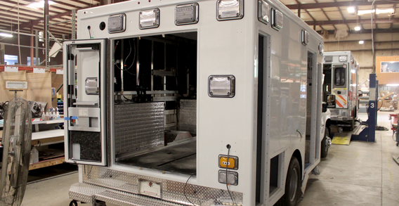 Rear curbside view of Type I white ambulance for Cahoun #2662 in box prep.