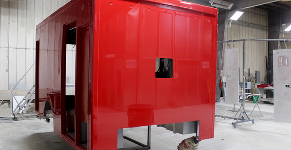 Front curbside corner view of NEFEA #2637 painted red. Type I red ambulance.
