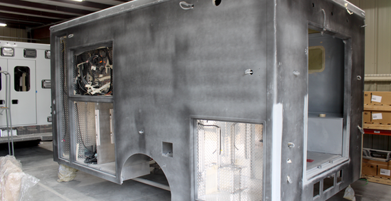 Rear driver side corner view of Muskogee #2654 in paint and body prep.