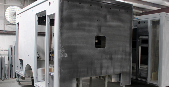 Front curbside corner view of Type I ambulance for Colquitt #2686 in paint and body prep.