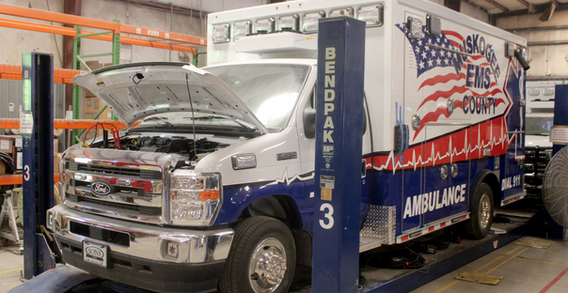 Front driver side view of Type III Muskogee Ambulance on Underbody lift.