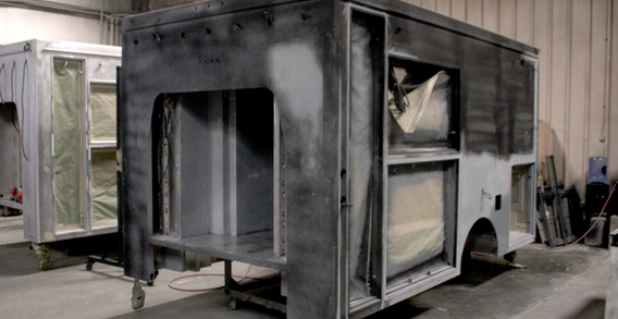 Front driver side view of Muskogee #2653 Type III ambulance in Paint. Primed Type III ambulance.