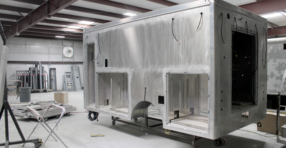 Rear driver side corner view of Monroe Type I ambulance from Custom Truck and Body Works, Inc. in paint and body prep.