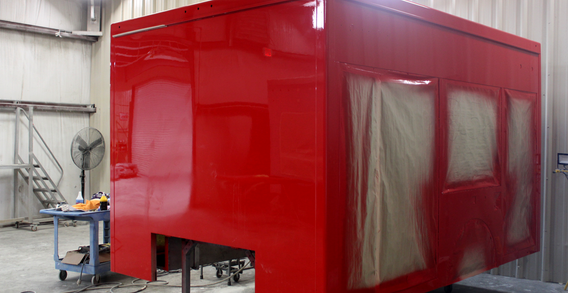 Front driver side corner view of 12' Rescue for Hwy. 58 #2569 painted red.