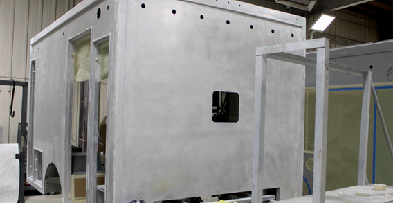 Front curbside corner view of Type I ambulance for Candler #2635 in paint and body prep.