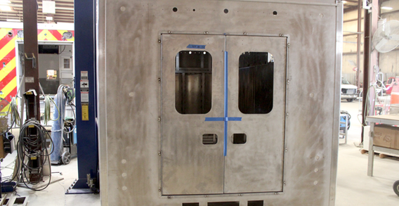 Rear view of Alamosa 15' Rescue #2638 on welding and fabrication lift.