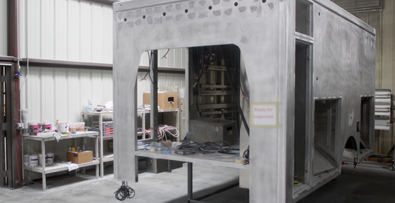 Front curbside corner view of Type III ambulance for Harrison #2677 in paint and body prep.