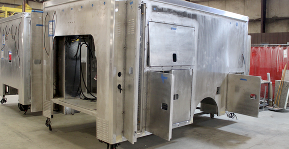 Front driver side corner view of metal Type III ambulance in welding and fabrication.