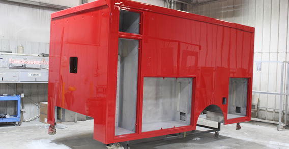 Front driver side corner view of NEFEA #2637 painted red. Type I red ambulance.