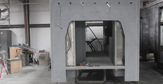 Front wall view of Muskogee #2653 in paint and body prep. Type III ambulance primed for paint.