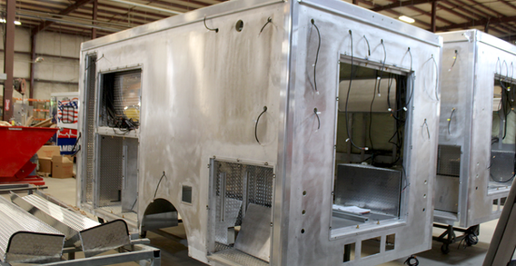 Rear driver side corner view of Muskogee #2656 in welding and fabrication. Aluminum fabricaiton for Type III ambulance.