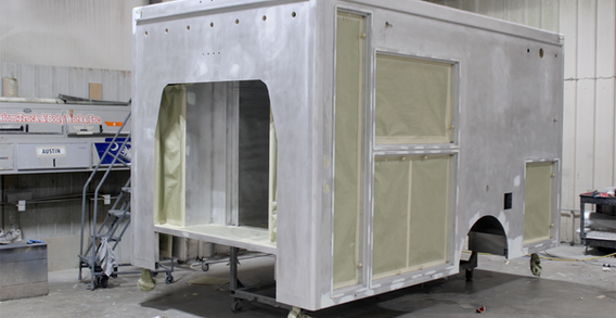 Front driver side corner view of Type III ambulance for Muskogee #2656 in paint and body prep.