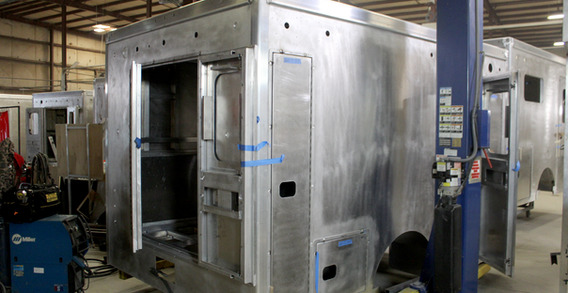 Rear curbside corner view of Grady #2627 on the welding and fabrication lift.