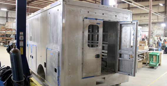Rear driver side corner view of Type I ambulance being built by Custom Truck and Body Works, Inc. for Monroe #2647