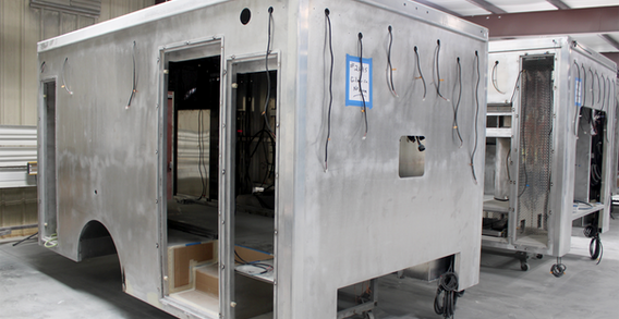 Front curbside corner view of Type I ambulance for Gilmer #2695 in paint and body prep.