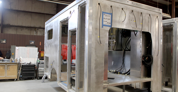 Front curbside corner view of Muskogee #2655 Type III ambulance in welding and fabrication.