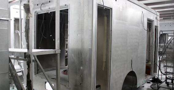 Rear curbside corner view of Fire Service #2689 in paint and body prep.