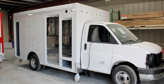 Front curbside corner view of White ambulance Type III for Harrison #2677.