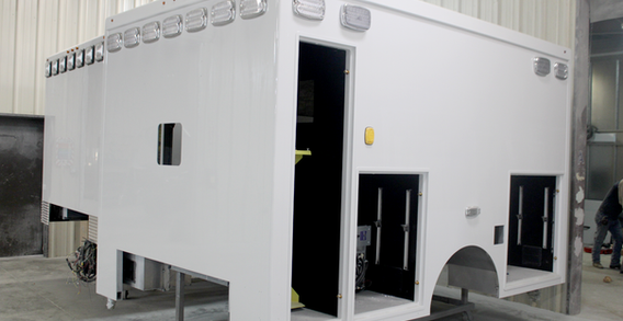 Front driver side corner view of EVO Stock #2586 Type  I ambulance in paint.