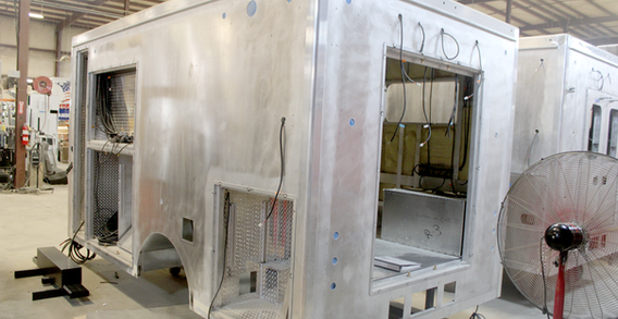 Rear driver side corner view of Muskogee #2657 Type III ambulance in welding and fabrication.