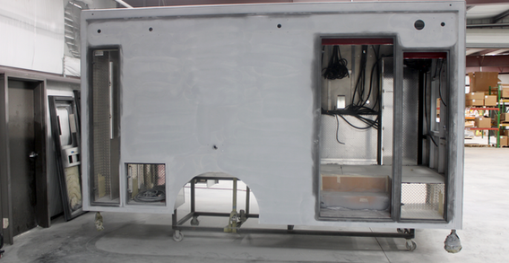 Curbside view of Type I ambulance for Monroe #2647 in paint and body prep.