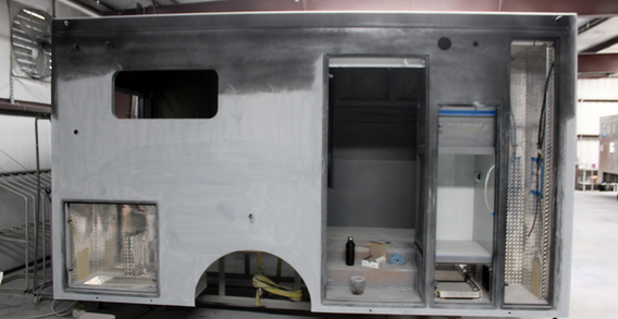 Curbside view of Type III ambulance for Muskogee #2653 in paint and body prep.