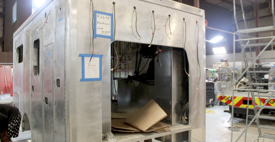 Front curbside corner view of Type III ambulance for Muskogee #2658 in welding and fabrication.