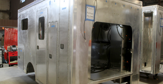 front curbside corner view of Muskogee #2657 in welding and fabrication. Type III ambulance in production front corner view.