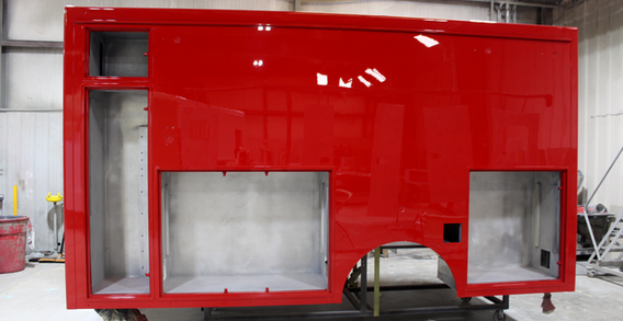 Driver side view of Type I red ambulance for NEFEA #2637 from Custom Truck and Body Works, Inc.