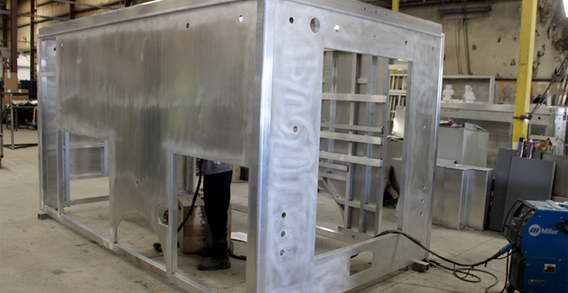 Rear driver side corner view of NEFEA #2637 in beginning stages of welding and fabrication. Type I ambulance being fabricated in the USA.