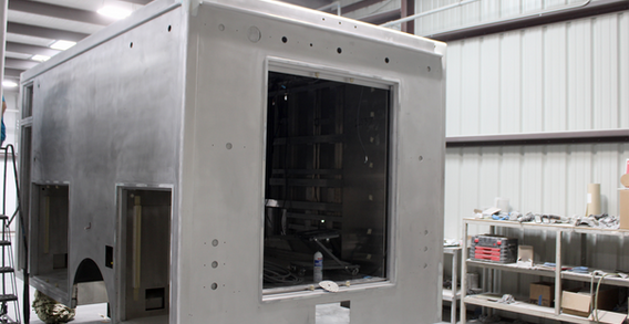 Type I metal fabricated ambulance from the rear driver side corner in paint and body prep.