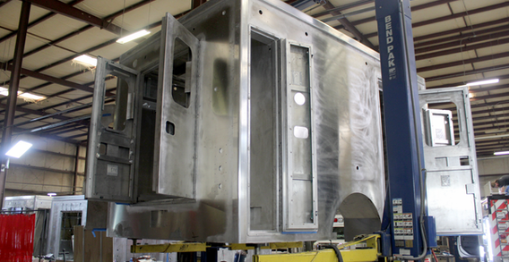 Rear curbside corner view of Washington #2697 on welding and fabrication lift.