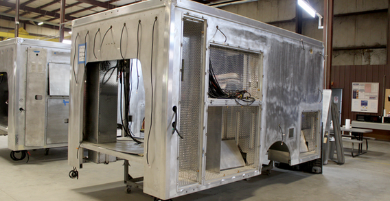 Rear curbside view of Muskogee #2656 in welding and fabrication showing the CNC cutouts and welds.