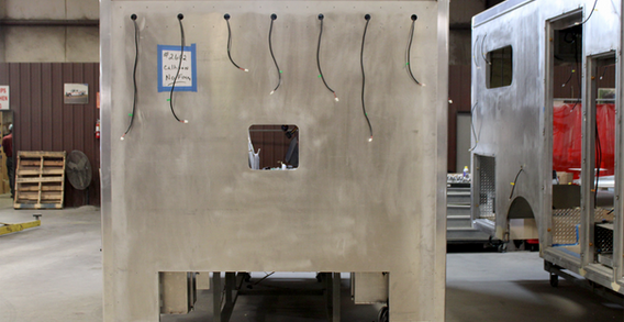 Front wall view of Calhoun #2662 in welding and fabrication. Type I ambulance from Custom Truck and Body Works, inc in welding and fabrication.
