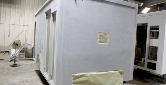 Front curbside corner view of NEFEA #2637 in paint prep. Type I ambulance primed for paint.