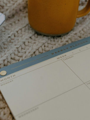 Planner and pen on a cozy surface representing New Year’s resolutions and goal setting