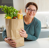Woman holding bag of groceries from the food pantry