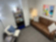 Close-up view of a therapy room with a comfortable chair and soft lighting