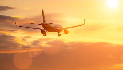 plane flies in sky towards sun..jpg